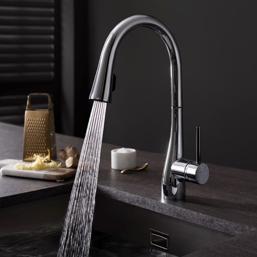 Product Lifestyle image of the Crosswater Cook Side Lever Kitchen Mixer with Concealed Dual Function Spray with its spray function activated