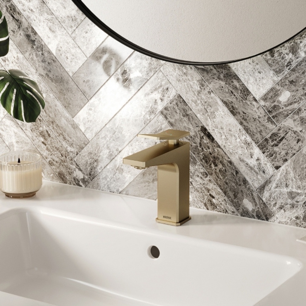 Lifestyle image of the Bristan Tangram Brushed Brass Basin Mixer Tap mounted on a rectangular basin