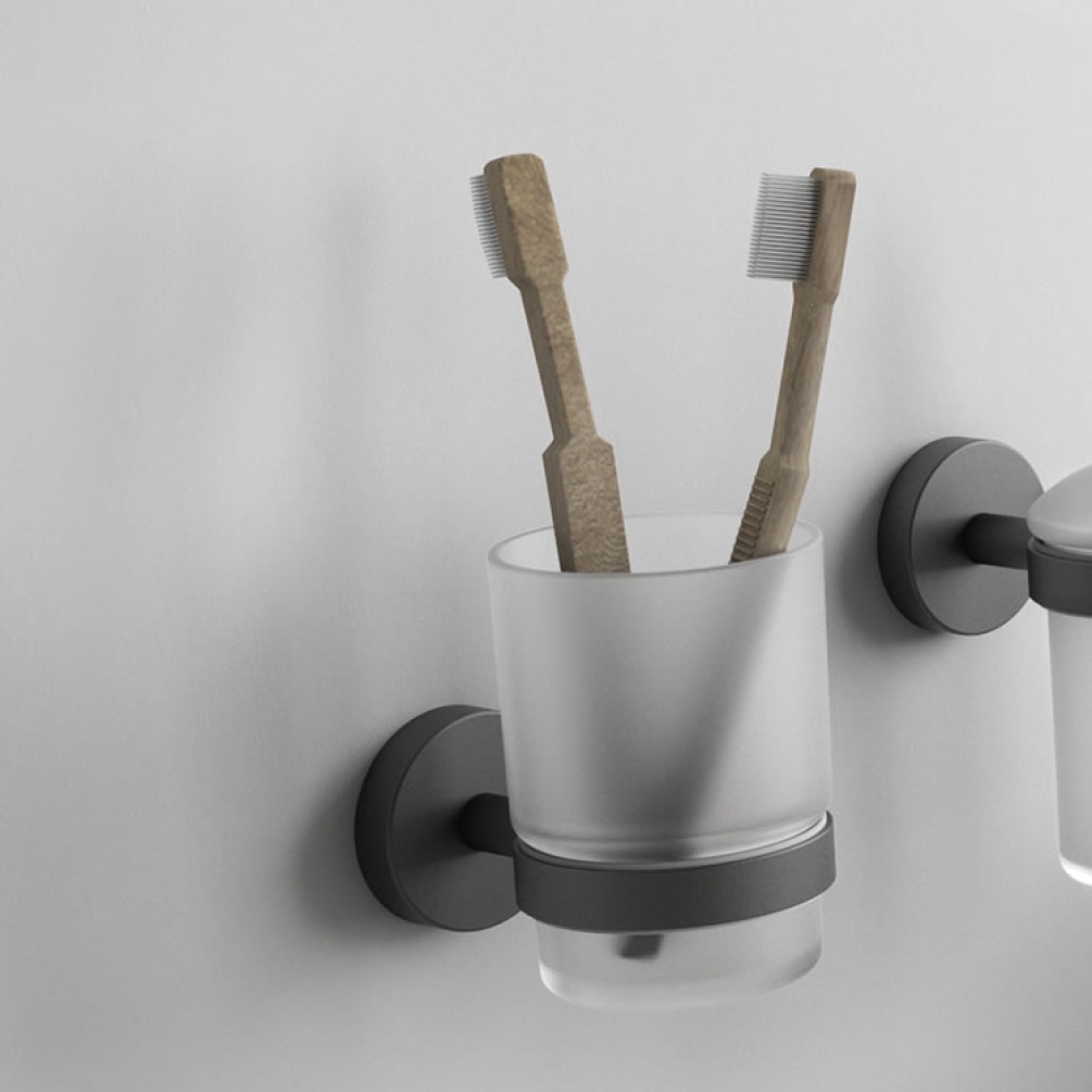 Lifestyle image of Origins Living Gedy Eros Tumbler Holder black mounted on white wall.
