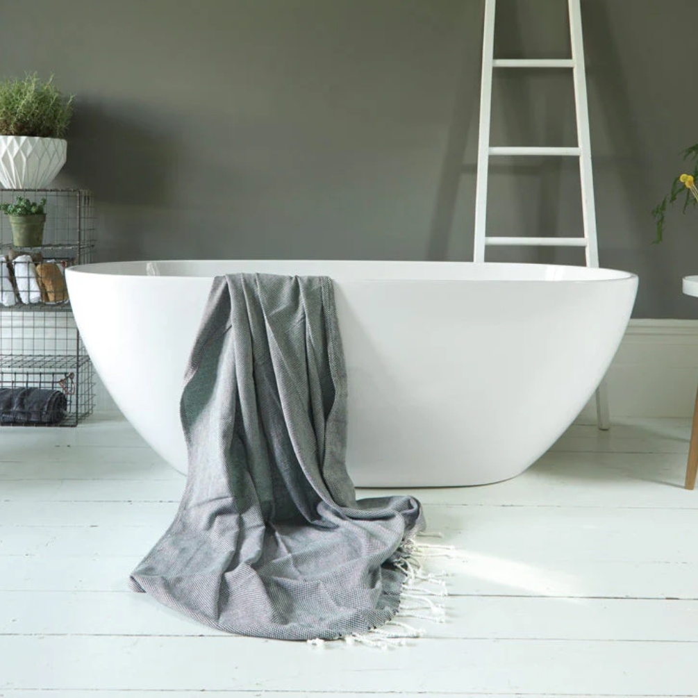 Lifestyle image of Waters Infinity Brook 1690mm Freestanding Bath with towel hanging over side - front angle