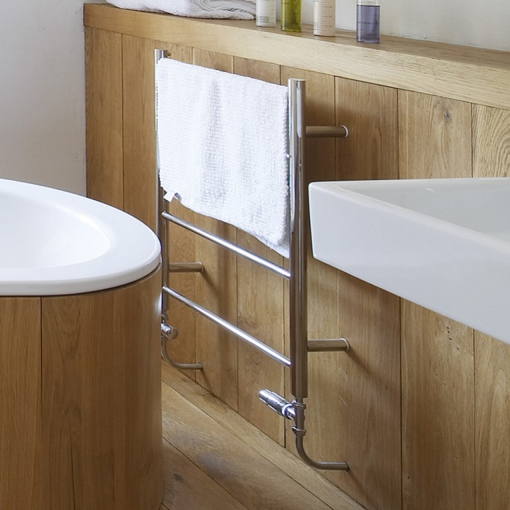 Product Lifestyle Image of The Sussex Range by JIS Rusper Heated Ladder Rail Close Up on Wooden Wall with towel - polished finish example RUSPER-P