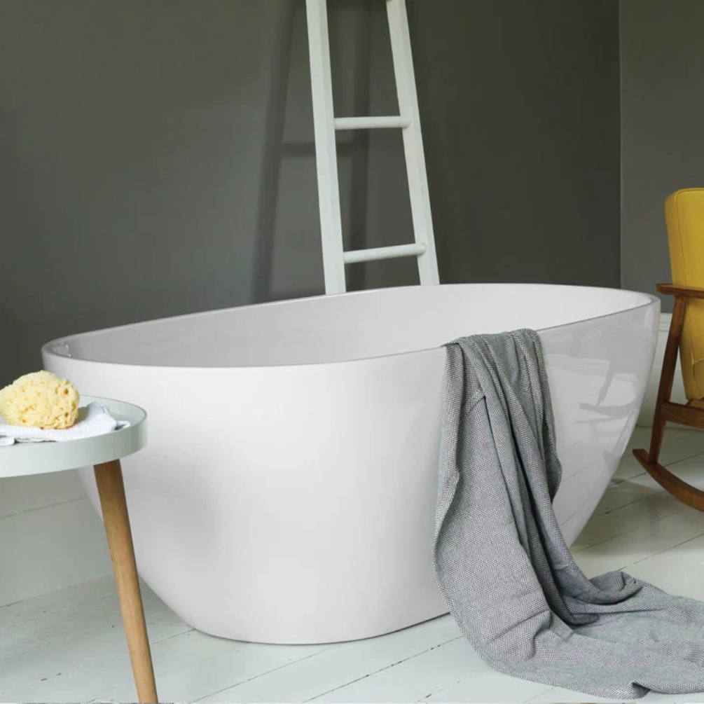 Product lifestyle image of Waters Infinity Brook 1540mm x 750mm Double Ended Freestanding Bath with grey towel next to ladder rail
