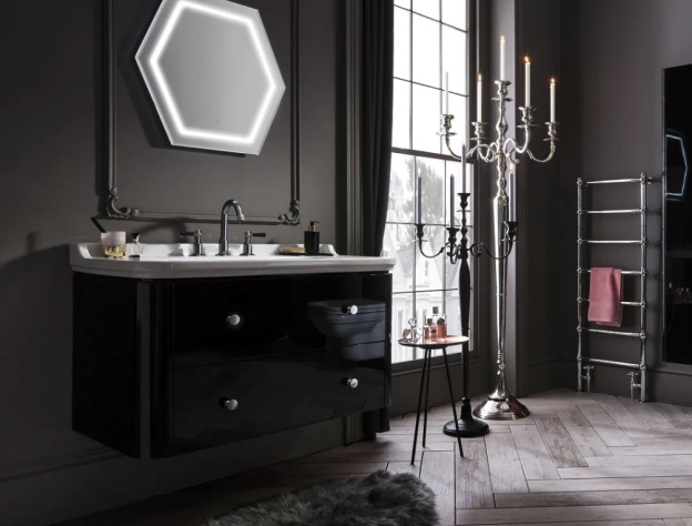 A black bathroom with black walls, furniture and accessories