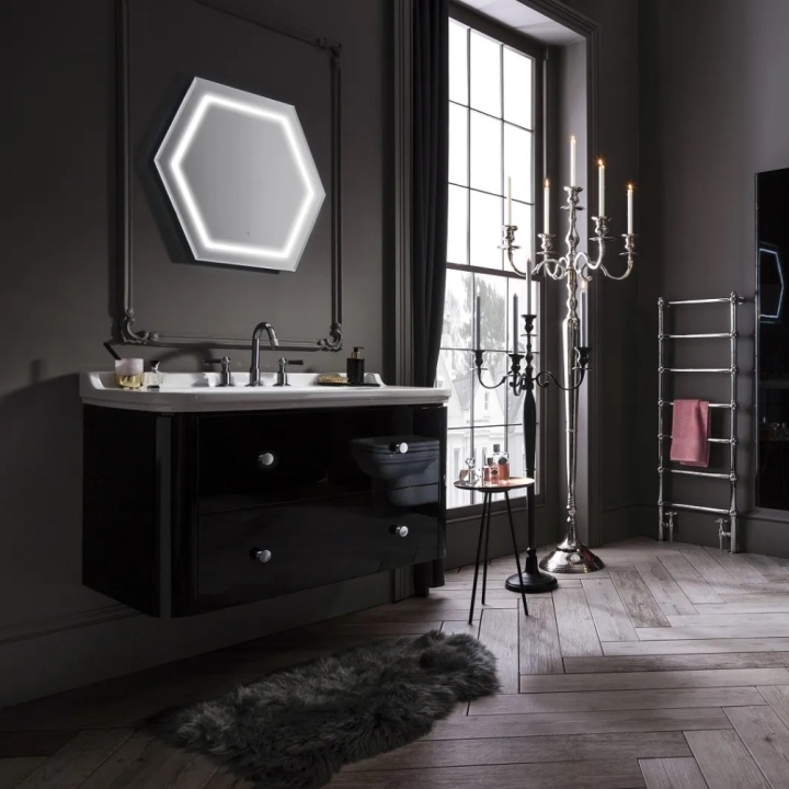 A black bathroom with black walls, furniture and accessories
