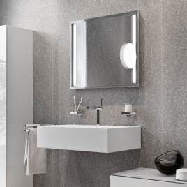 Product Lifestyle image of an assortment of Keuco Edition 90 fixtures and accessories, including a light mirror, mono basin mixer tap, soap dispenser, tumbler holder and double towel rail