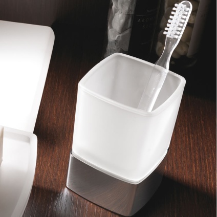 Lifestyle image of Origins Living Gedy Lounge Freestanding Tumbler Holder Chrome on brown surface.