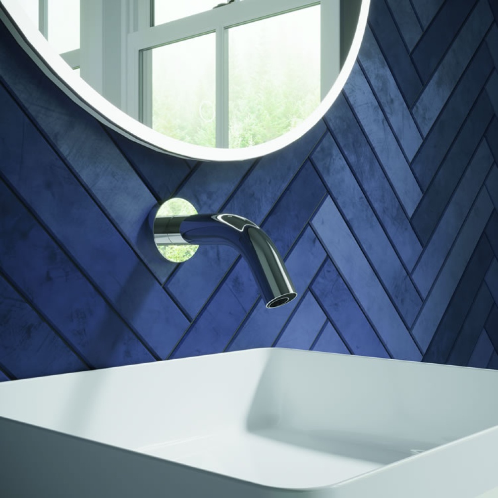 Lifestyle image of MPRO Sensor Basin Wall-Mounted Spout 208mm Chrome mounted over white basin against blue tiles.