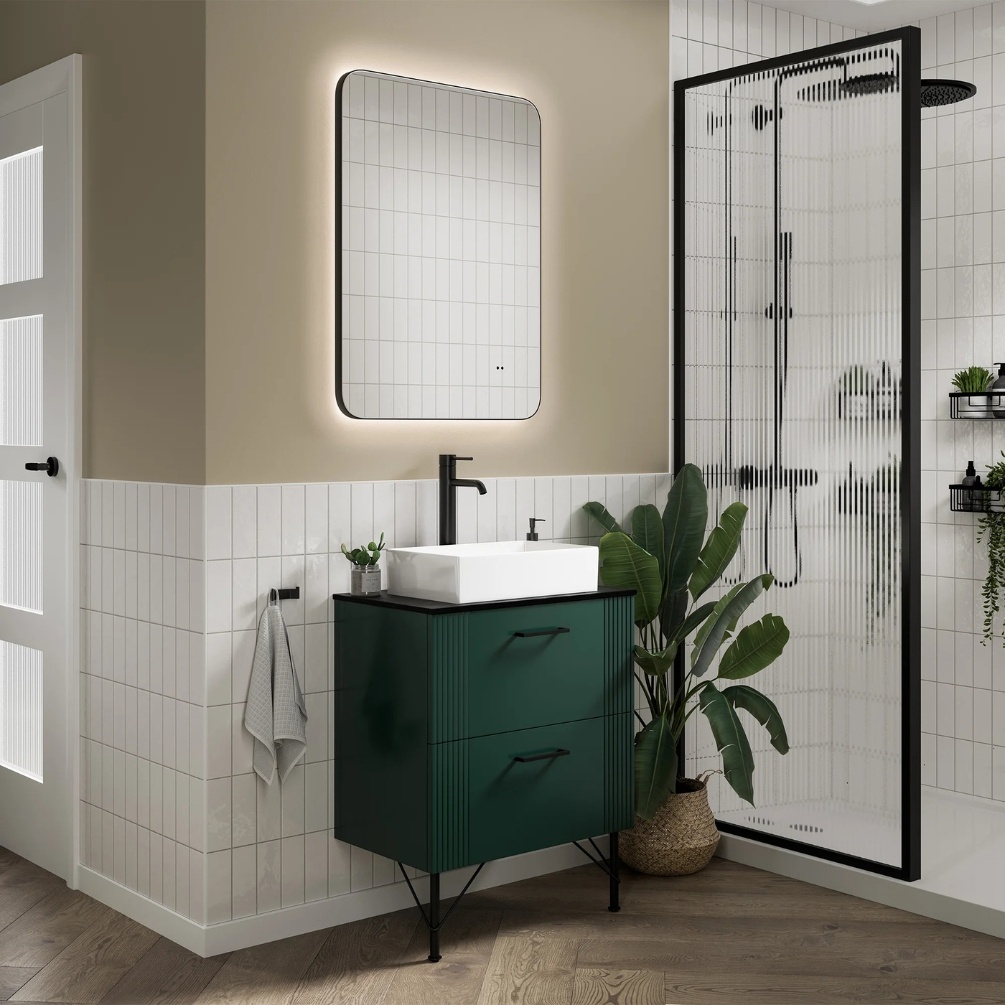 Lifestyle image of the hib. Arcane Curve 500mm x 700mm Black Illuminated Frame Mirror mounted above a green freestanding vanity unity & basin