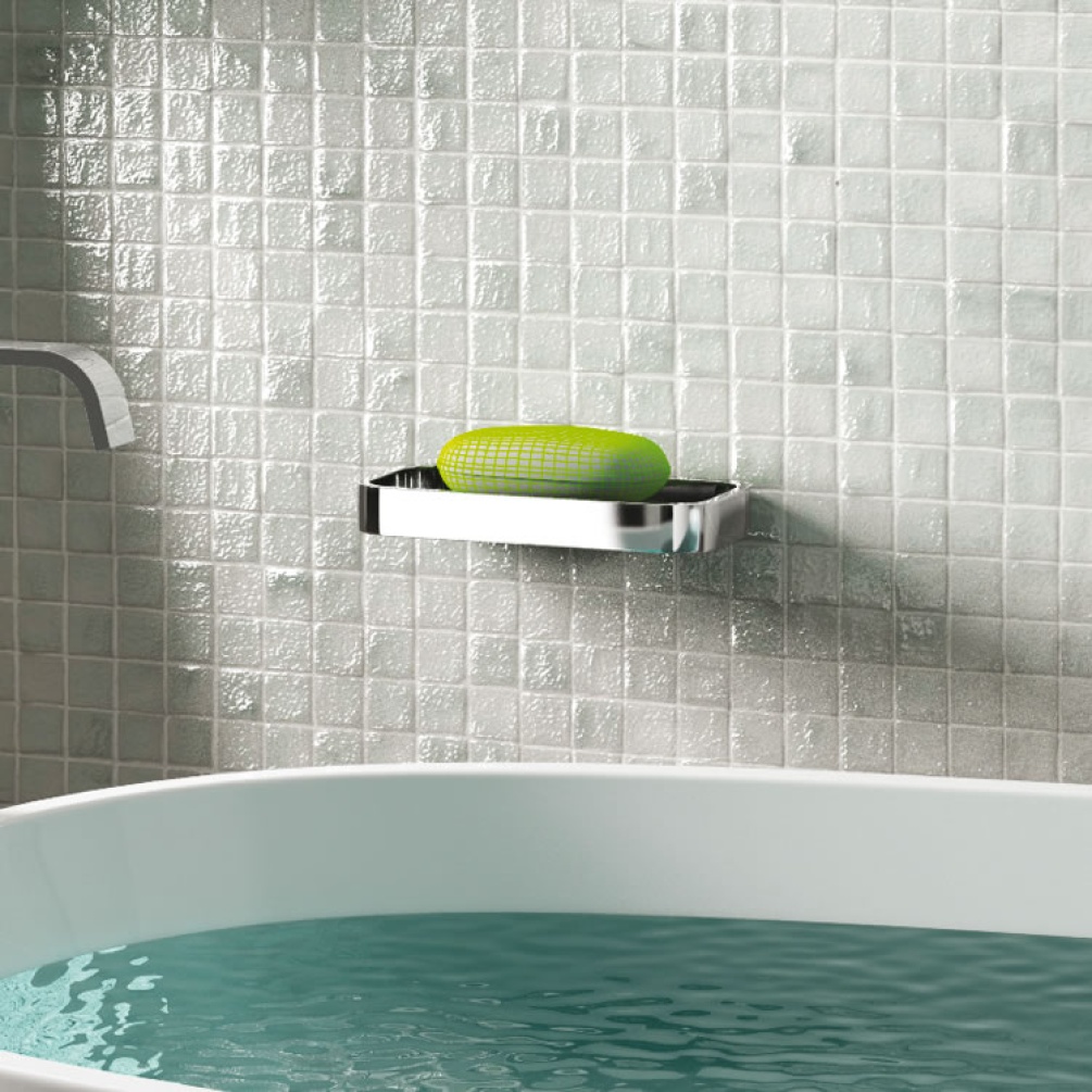 Lifestyle image of Origins Living Gedy Outline Shower Basket chrome mounted on grey-white tiled wall.