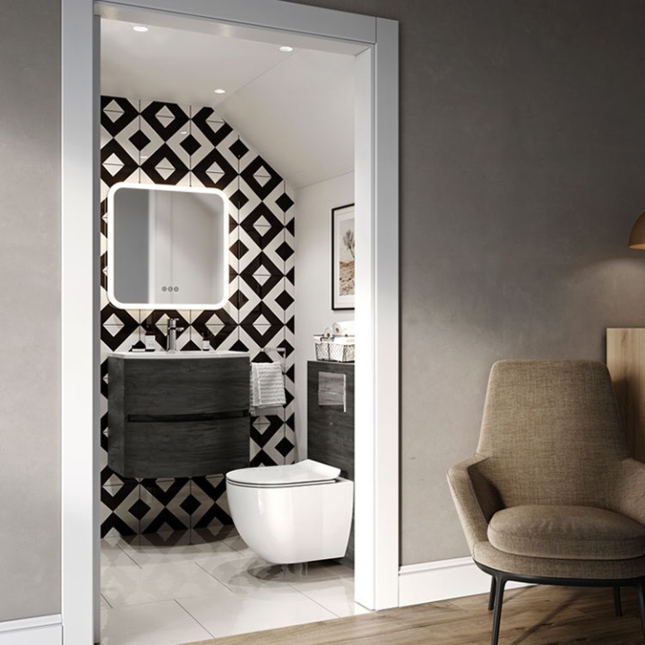 Product Lifestyle image of the Crosswater Abstract Suite, featuring a wall mounted toilet, black and white wall tiles, a wall hung washbasin unit and a LED mirror