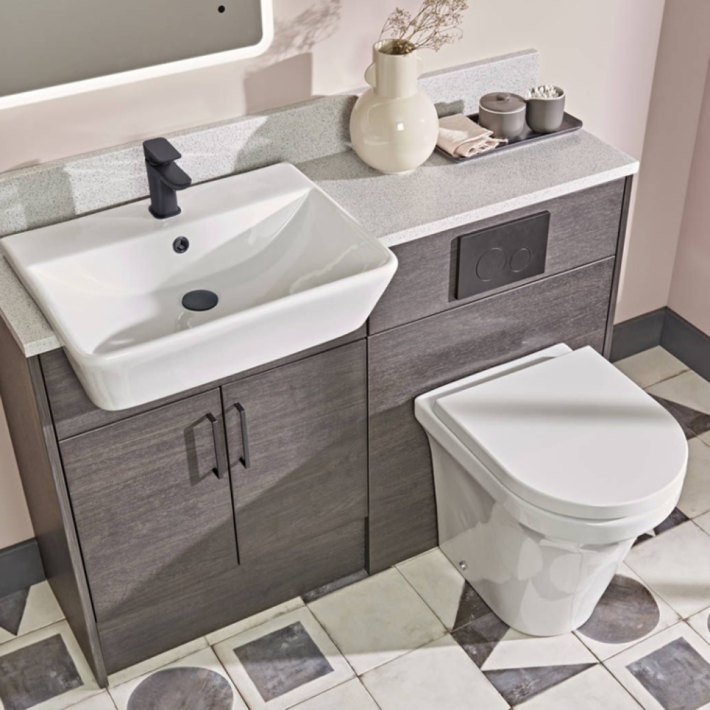 Lifestyle image of the Tavistock Aerial Back To Wall Comfort Height Toilet attached to a vanity unit