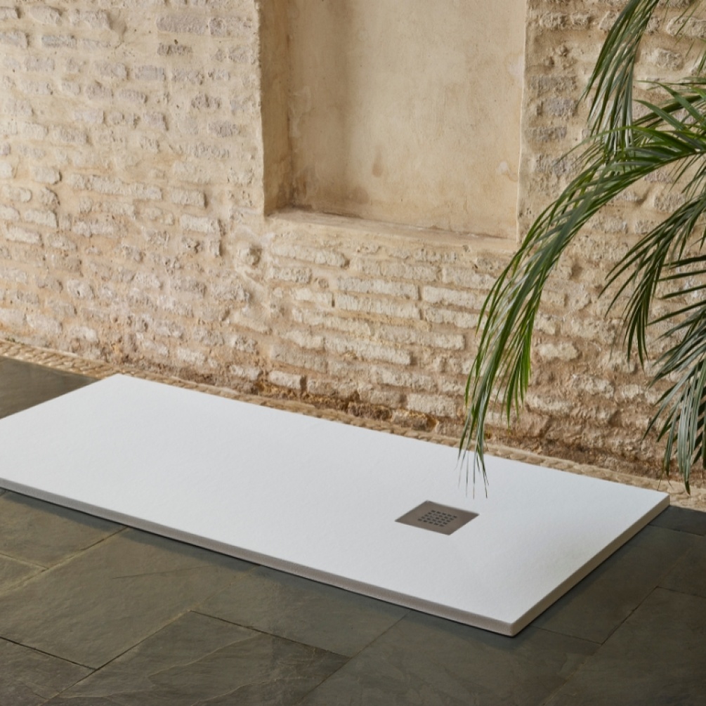 Product Lifestyle image of the Doccia Lipari White Slate 1600mm x 800mm Shower Tray in a room with brick walls