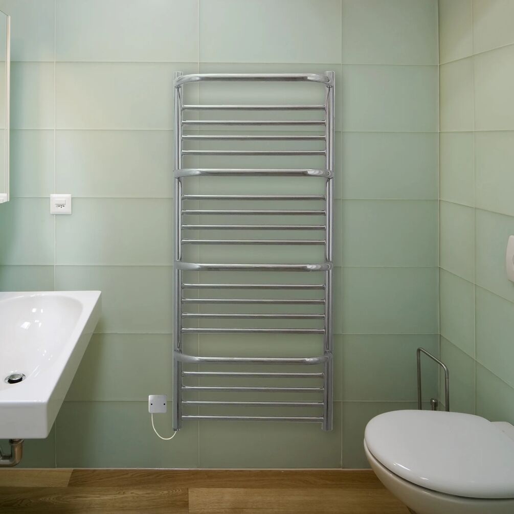 Lifestyle image of the The Sussex Range by JIS Findon 1210mm x 540mm Polished Stainless Steel Electric Towel Rail installed in a bathroom with wall-hung basin and toilet