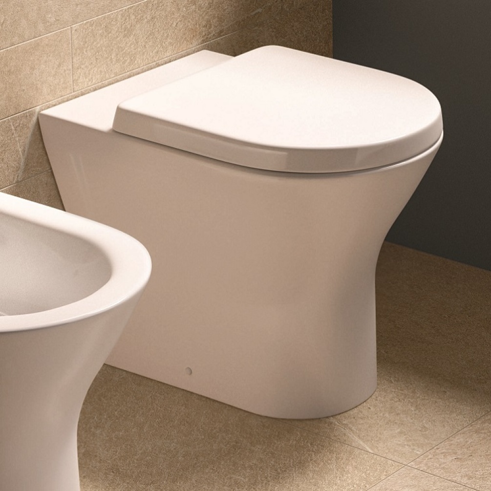Product Lifestyle image of Rak Resort Back to Wall toilet with Wrap over toilet seat in bathroom RSTBTWPAN RAKSEAT006