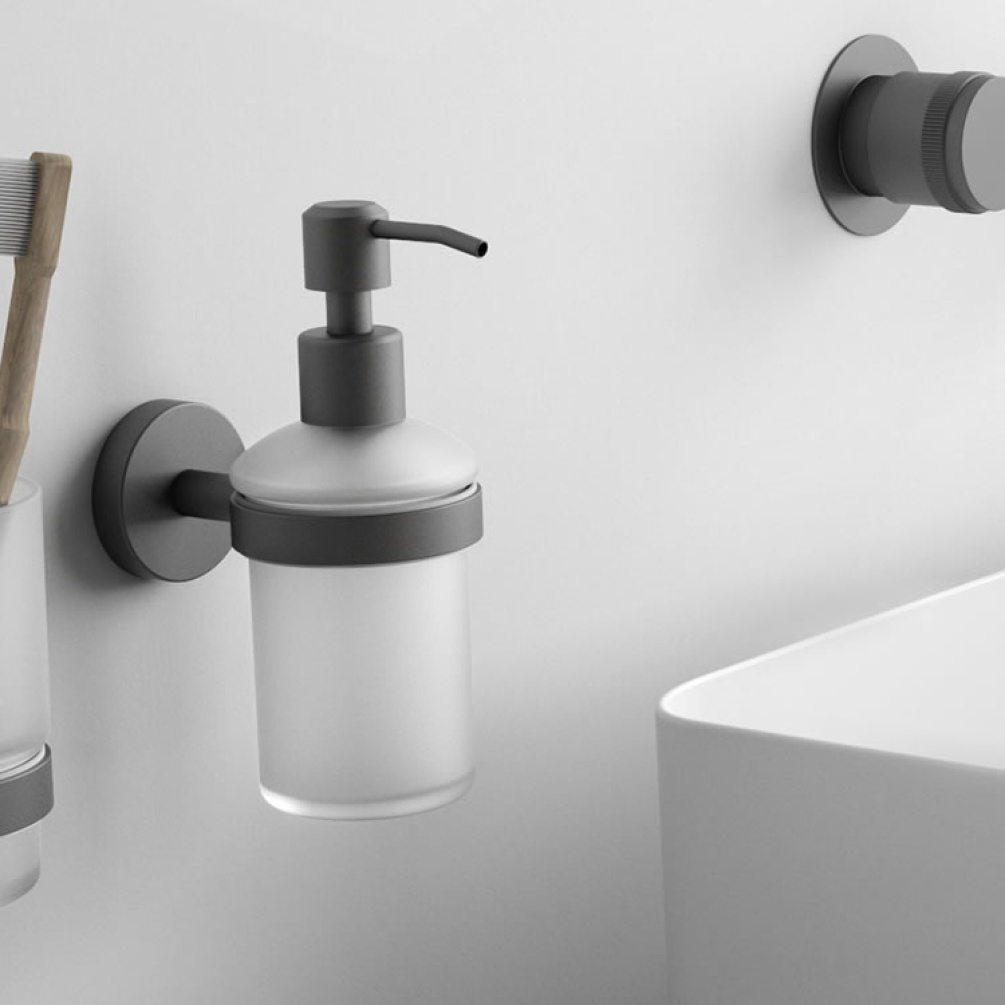 Lifestyle image of Origins Living Gedy Eros Glass Soap Dispenser chrome mounted on white wall..