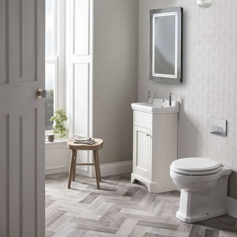 Lifestyle image of the Tavistock Vitoria Back to Wall Toilet installed next to a vanity unit