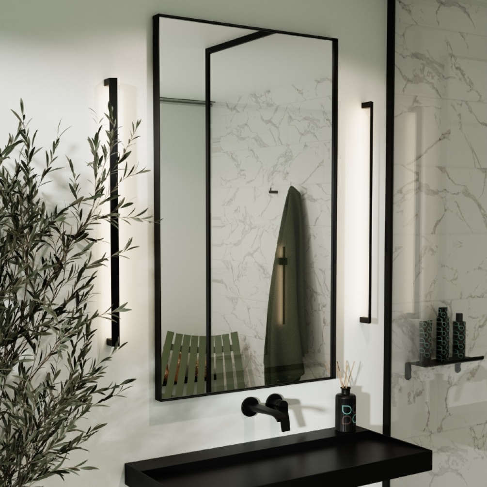 Product Lifestyle image of Origins Living Newington 600mm x 800mm Black Rectangular Mirror on an angle on a bathroom wall NWG-001068-BK