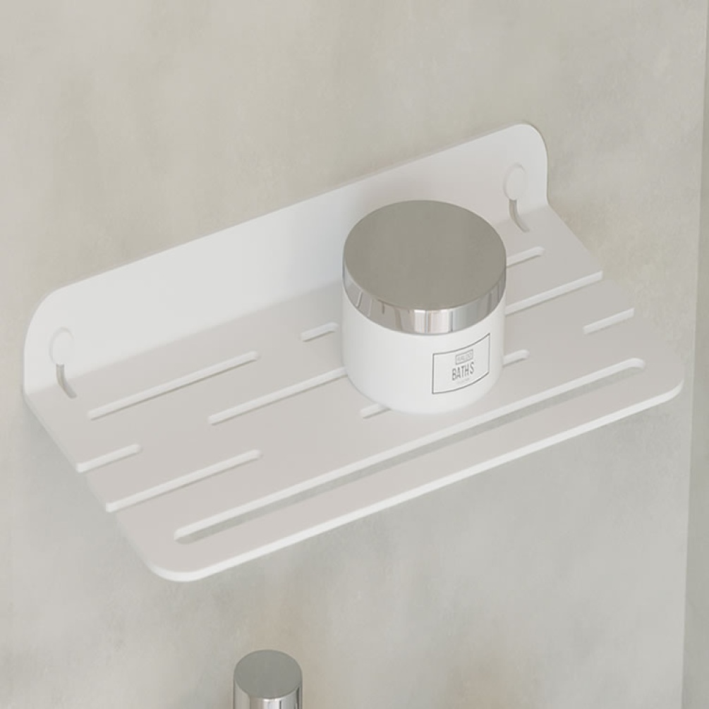 Lifestyle image of Origins Living Sonia Quick Open Shower Shelf White mounted on marble white wall with jar on top.