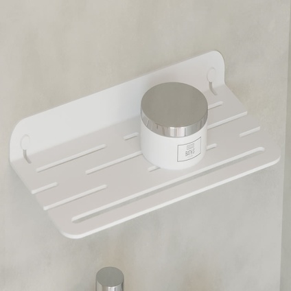 Lifestyle image of Origins Living Sonia Quick Open Shower Shelf White mounted on marble white wall with jar on top.
