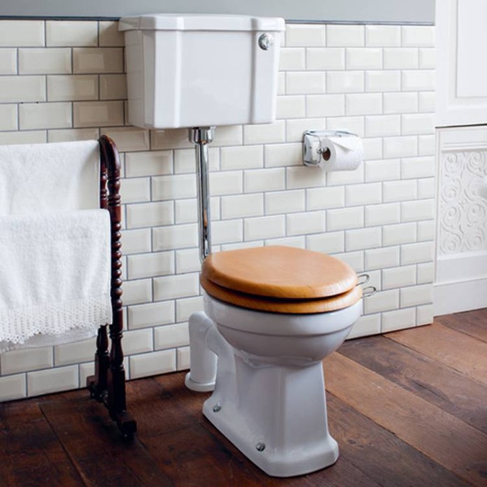 Product Lifestyle image of the Burlington Low Level Toilet with Push Button and an Oak Toilet Seat
