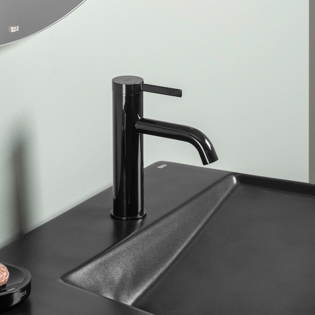 Lifestyle image of the Roca Ona Titanium Black Basin Mixer Tap with Click-Clack Waste installed on the deck of a basin