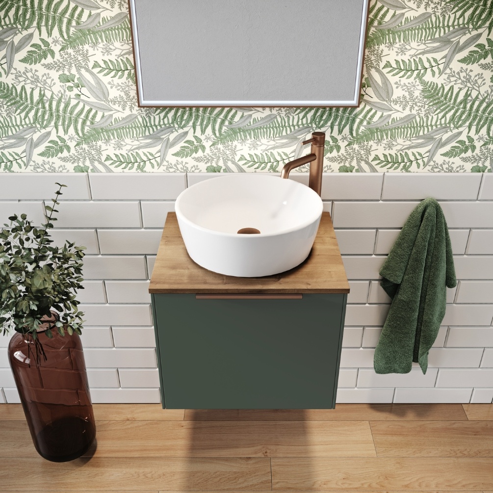 Product Lifestyle image of the Abacus Concept Sit On Sage Green 550mm Vanity Unit topped with a round countertop basin