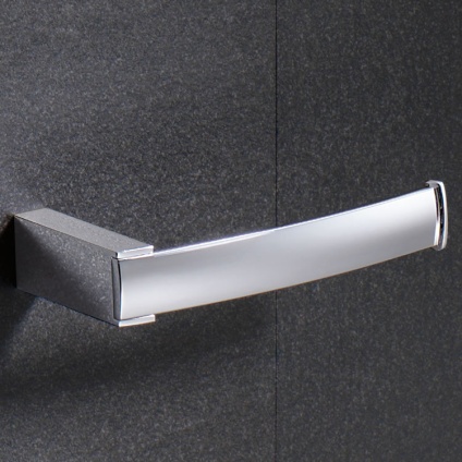Lifestyle image of Origins Living Gedy Kent Open Toilet Roll Holder mounted on dark grey textured tiles.