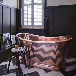 image of a bc designs copper bath in bathroom with black and white zig zag tiles