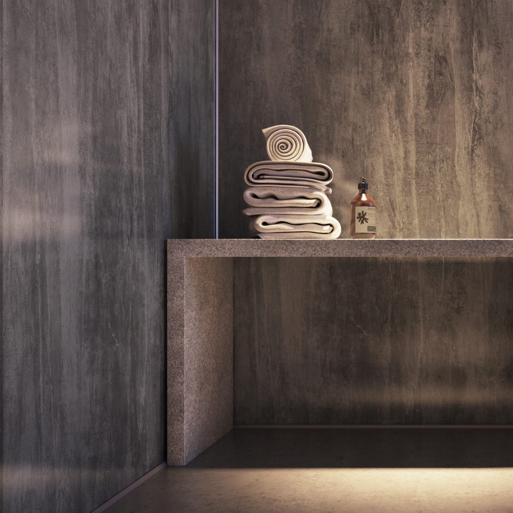 Close up lifestyle image of the Showerwall Laminate Washed Charcoal 2440mm x 1179mm Proclick Ply Wall Panel - SW58 installed in a bathroom with matching grey table