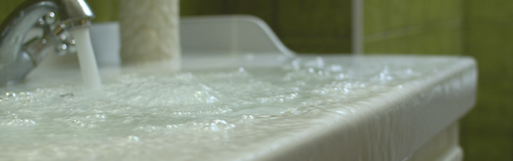 Close up image of an overflowing bathroom sink