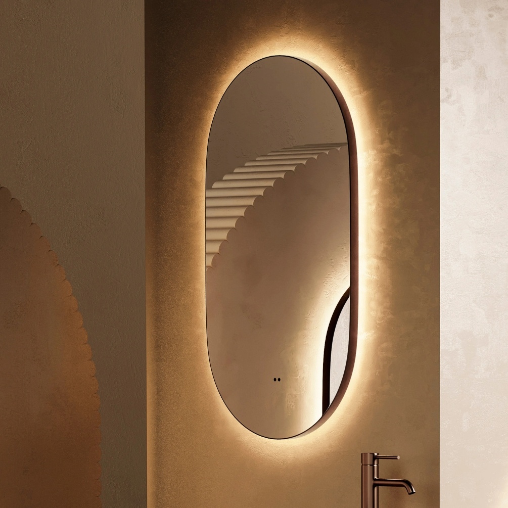 Lifestyle image of the hib. Arcane Pill 500mm x 900mm Brushed Bronze Illuminated Frame Mirror