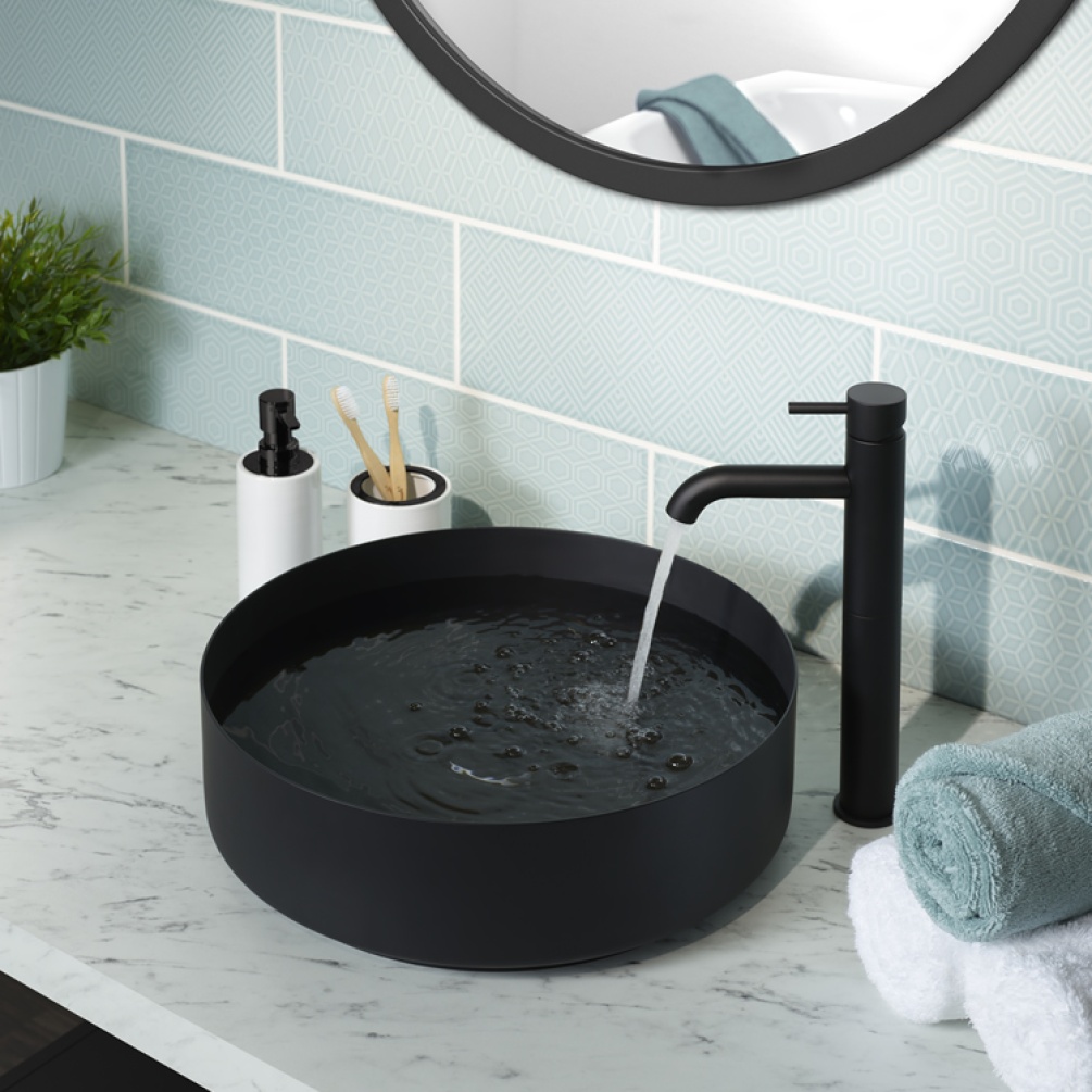 Close up product lifestyle image of the JTP Vos Matt Black Stainless Steel Round Countertop Basin