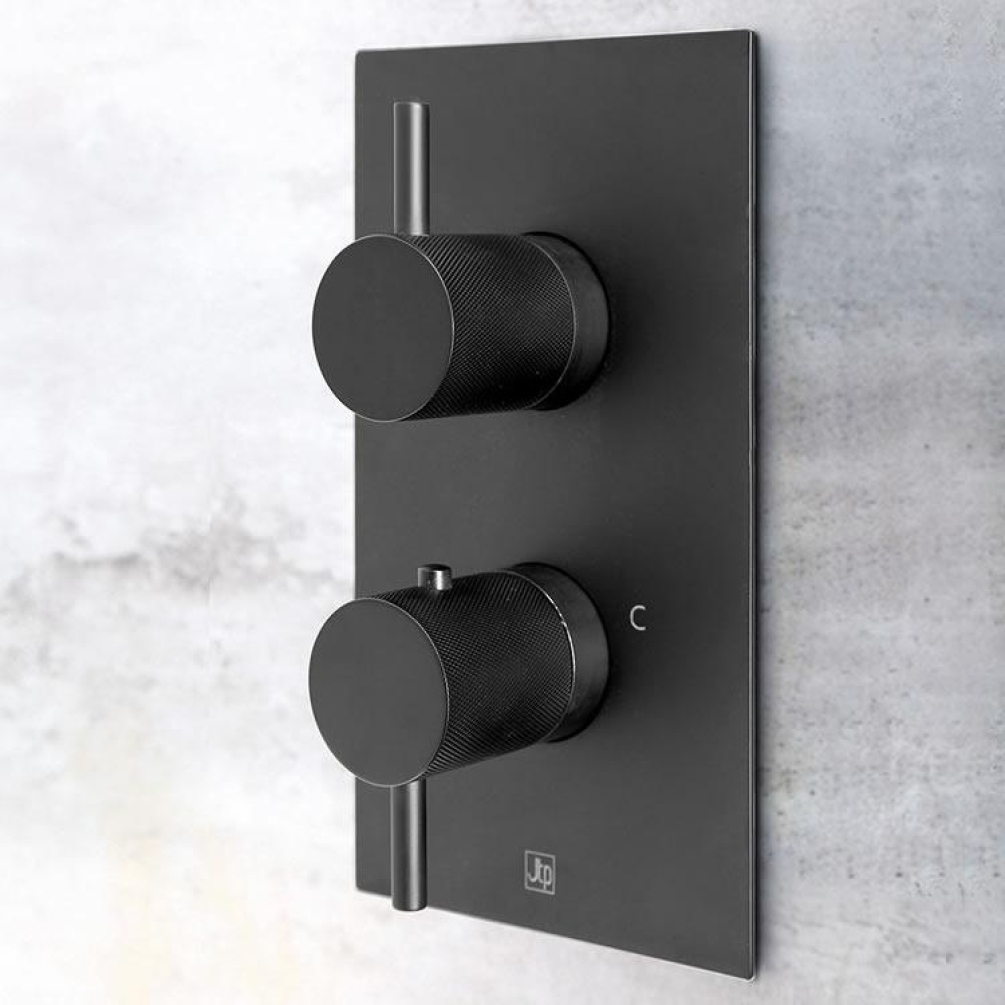 Close up product lifestyle image of the JTP Vos Matt Black Dual Outlet Shower Valve with Designer Knurled Handles