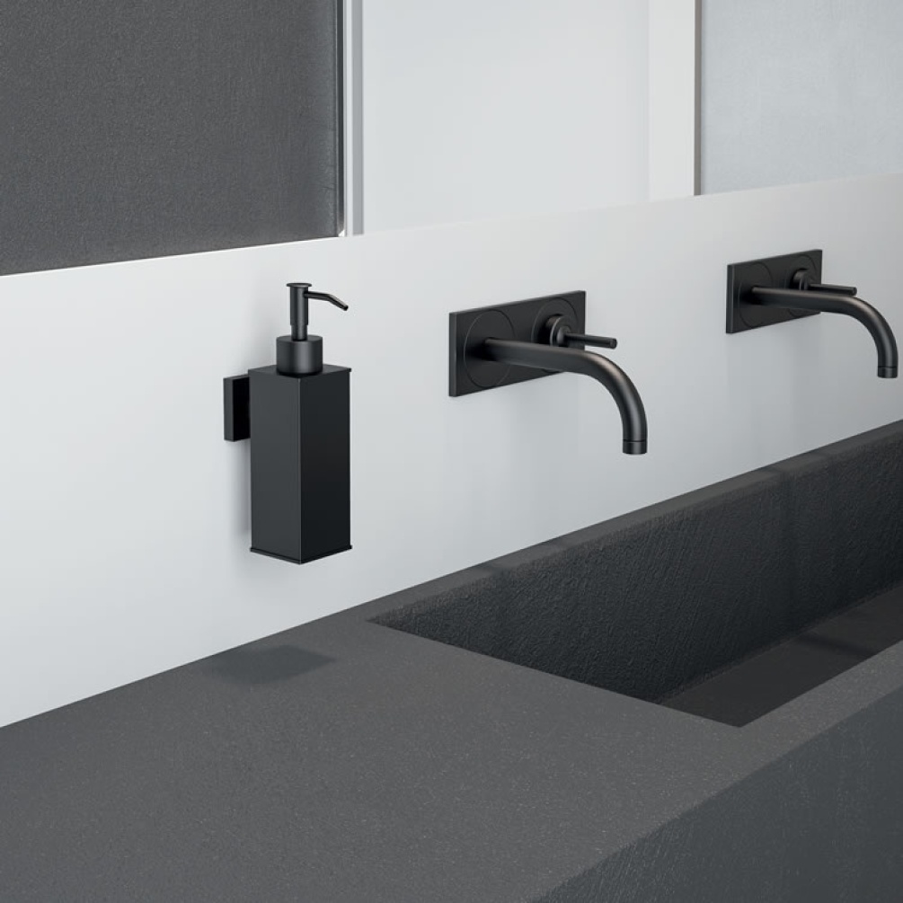 Lifestyle image of Origins Living Gedy Seal Square Dispenser black mounted on white wall above black worktop.