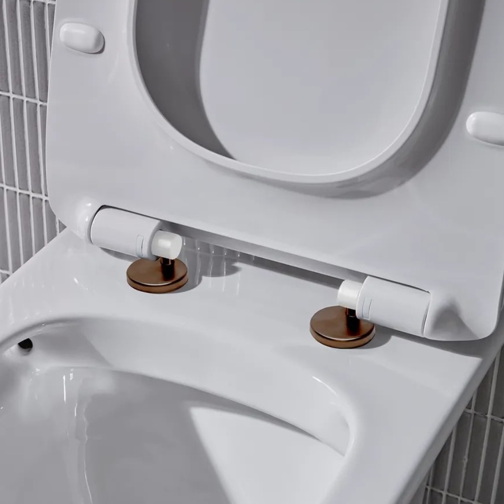 Lifestyle image of the Tavistock Loft Brushed Bronze Wrap Over Toilet Seat Hinge Cover Caps