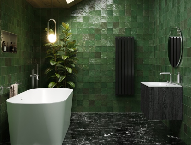 A biophilic bathroom with green tiles, freestanding bath, marble floor and skylight