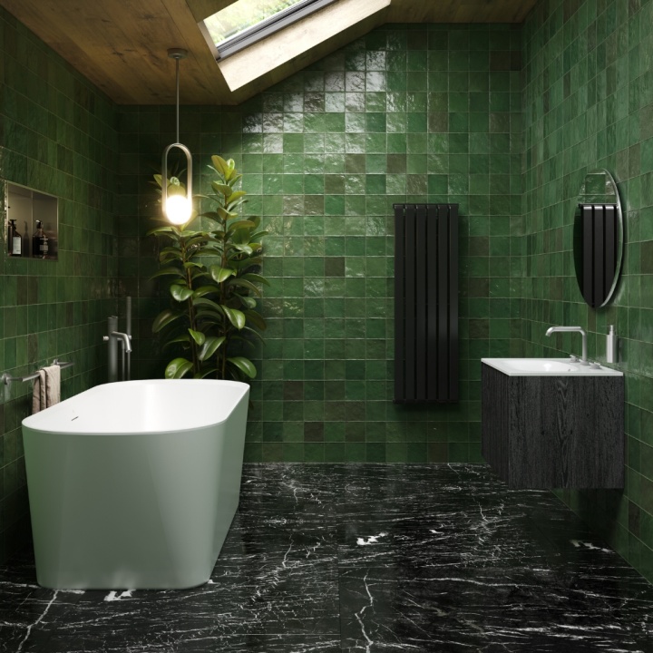 A biophilic bathroom with green tiles, freestanding bath, marble floor and skylight