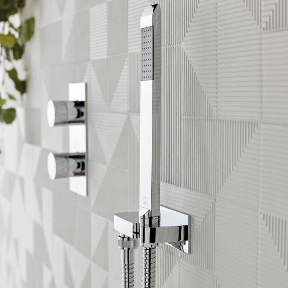 Lifestyle image of Omika Single Function Handset with Hose and Bracket with Integrated Outlet.