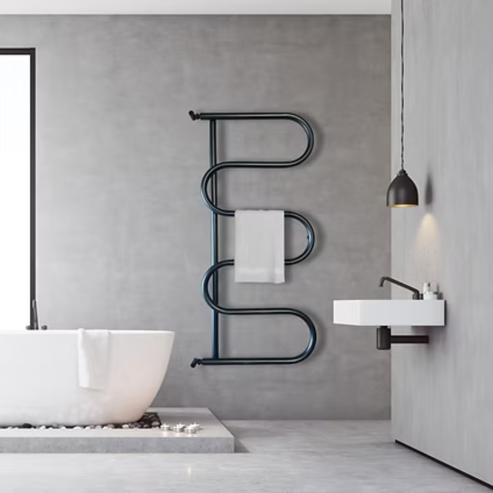 Lifestyle image of the Radox Ondo 1380mm x 600mm Matt Black Heated Towel Radiator, mounted on a wall, next to a freestanding bath and wall-mounted basin