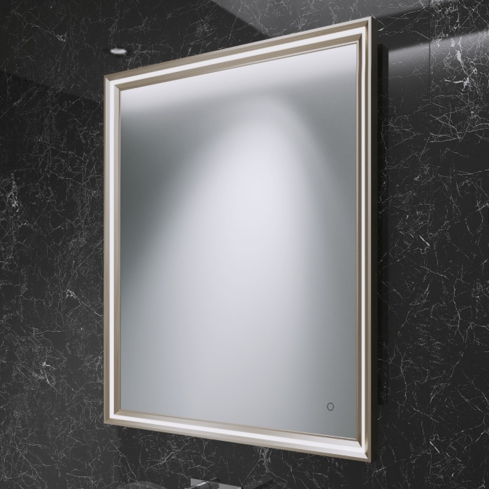 Image of Origins Living Lexington Mirror in Brushed Bronze rectangular shape against a dark marble wall