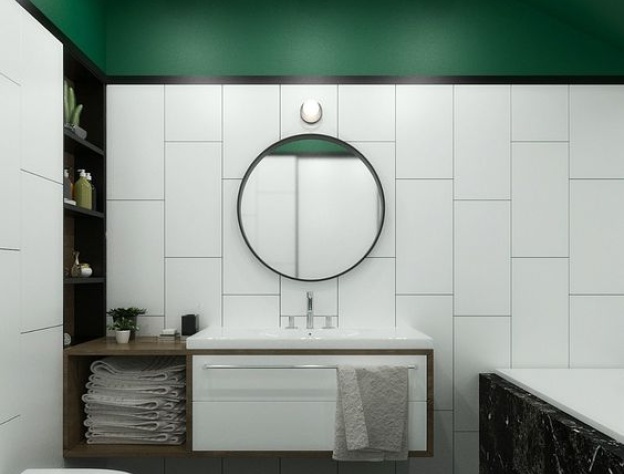 Lifestyle image of a green and white bathroom design, featuring white wall tiles and a green painted ceiling