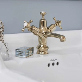image of a burlington claremont basin tap on basin in gold finish next to soap bar