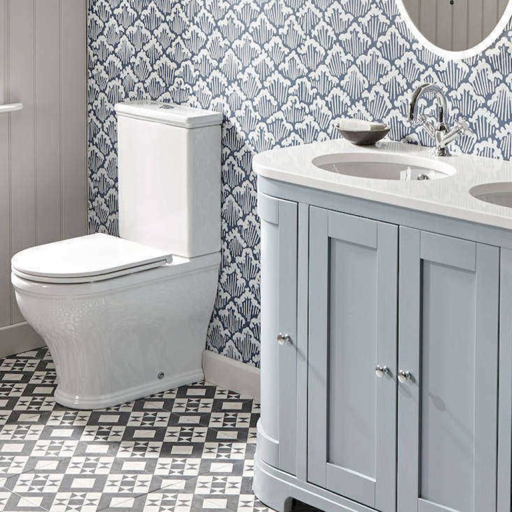 Lifestyle image of the Tavistock Lansdown Close Coupled Short Projection Back to Wall Toilet installed next to a double vanity unit with basins