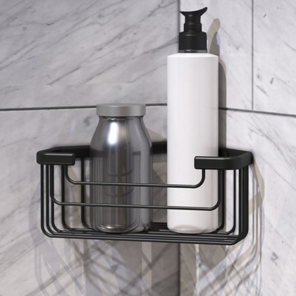 Lifestyle image of Origins Living Gedy Deep Corner Basket black mounted on white-grey tiles.