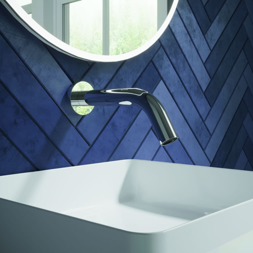 Lifestyle image of MPRO Sensor Basin Wall-Mounted Spout 208mm Chrome mounted on white basin against blue tiles.