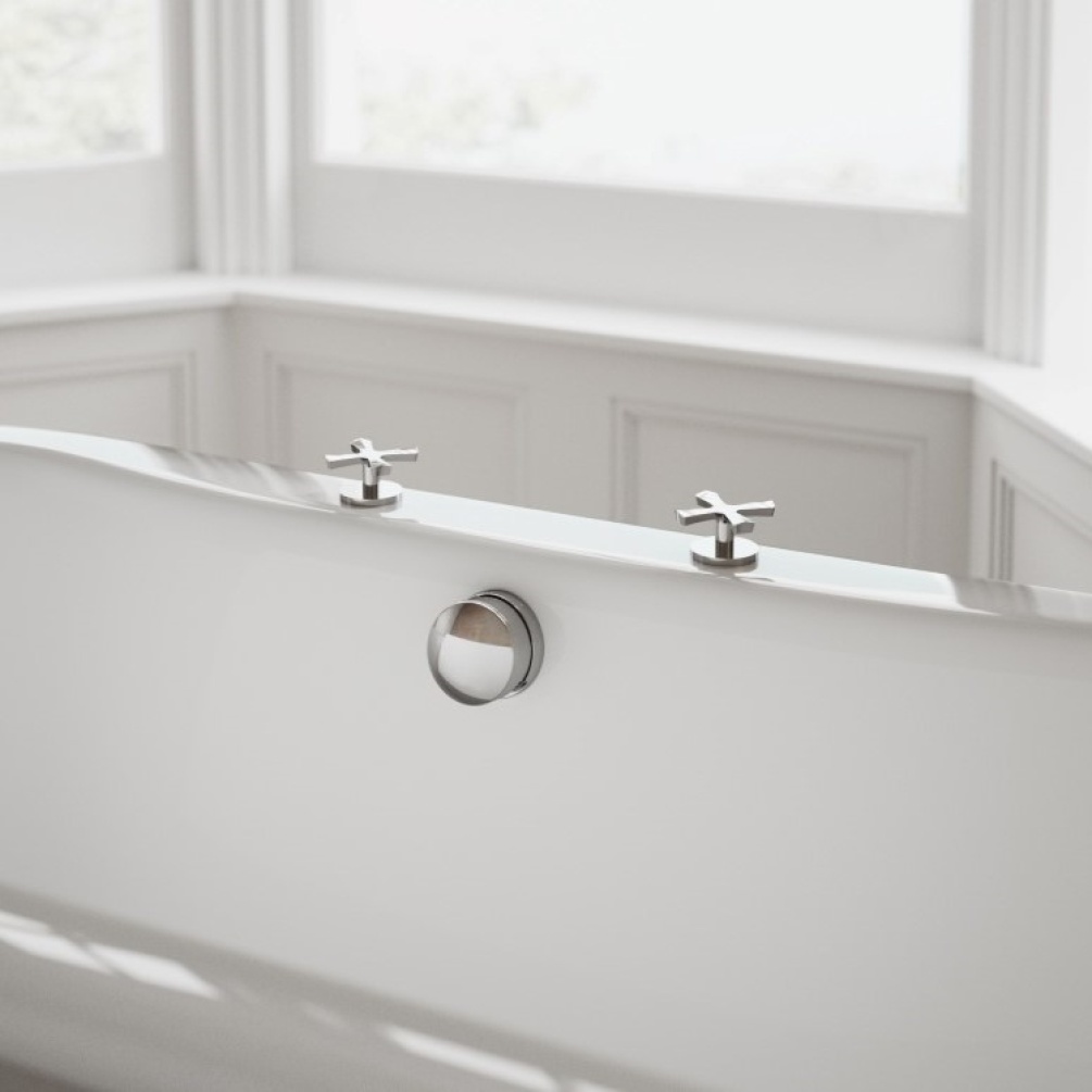 Product Lifestyle image of the Burlington Riviera Chrome Deck Mounted Bath Panel Valves in bathroom mounted on bath with chrome bath filler and window in background