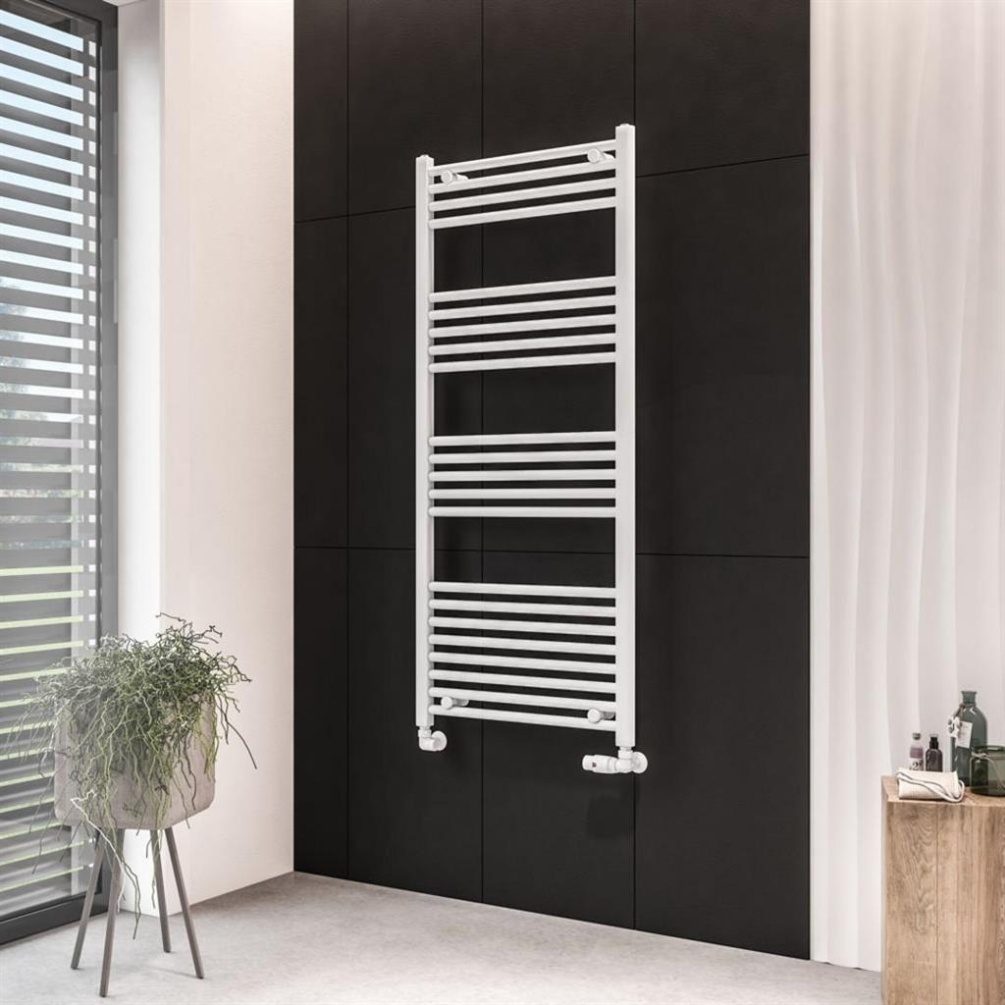 Lifestyle image of the Eastbrook Wingrave 1400mm x 600mm Matt White Heated Towel Rail mounted on a black bathroom wall