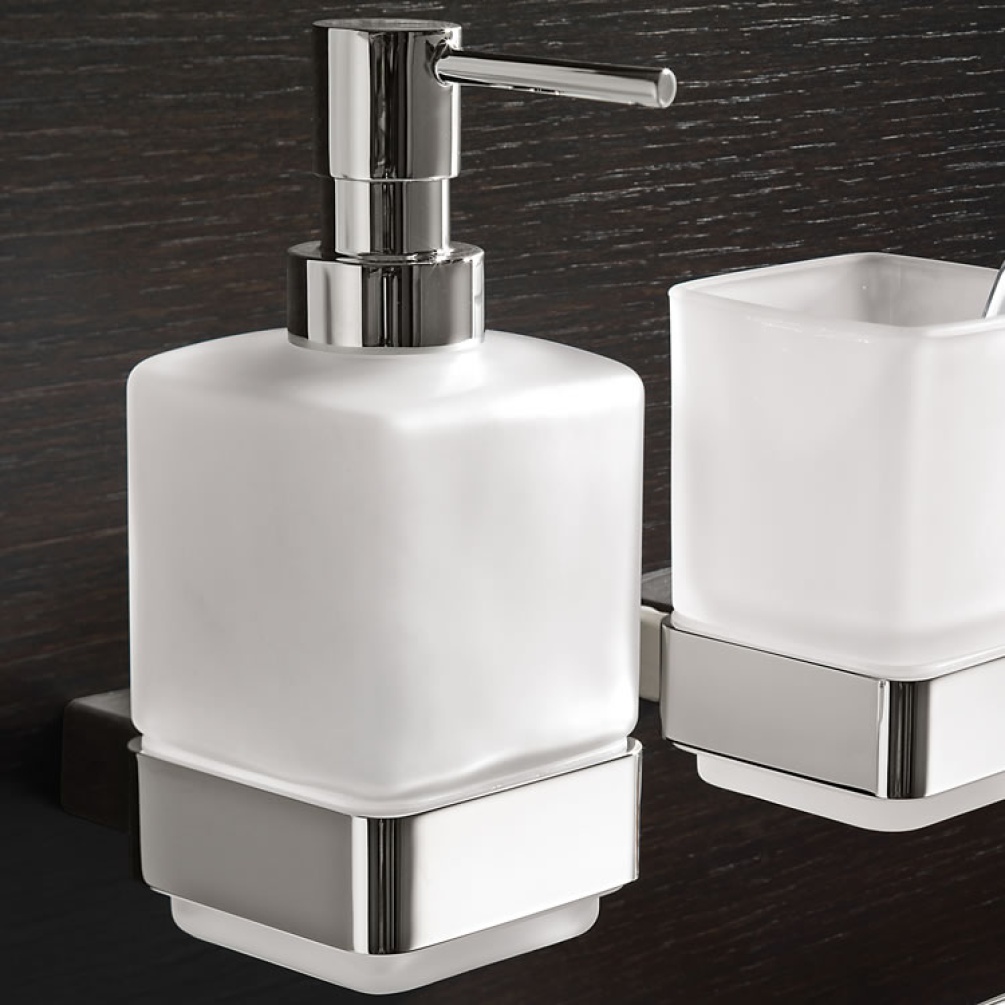 Lifestyle image of Origins Living Gedy Lounge Wall-Mounted Soap Dispenser mounted on black wall.