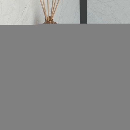 Lifestyle image of Origins Living Sonia Quick Toilet Roll Holder with Shelf Black mounted on marble white wall with incense sticks on shelf.