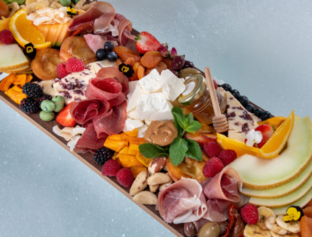 Close up image of a charcuterie board laid across a bathtub